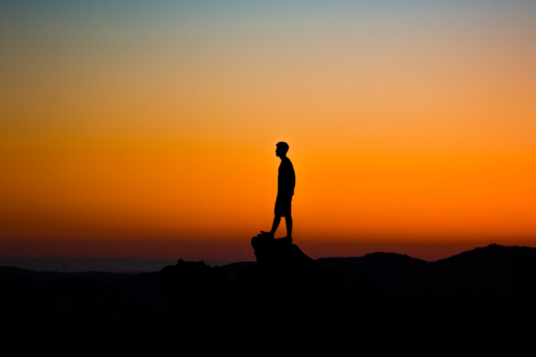 Photo by Austin Mabe silhouette of man during sunset